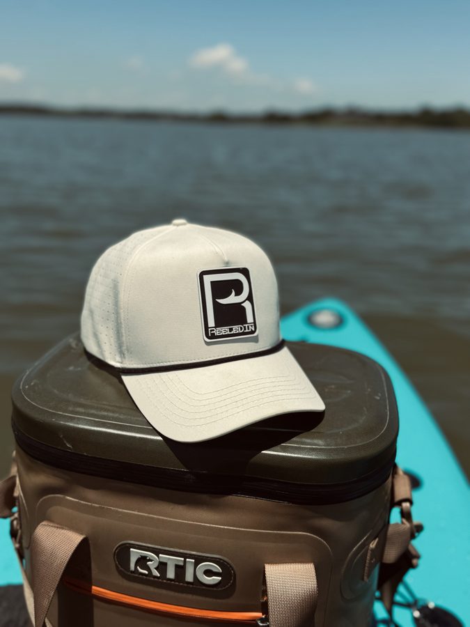 Reeled In hat on a kayak at the ramp