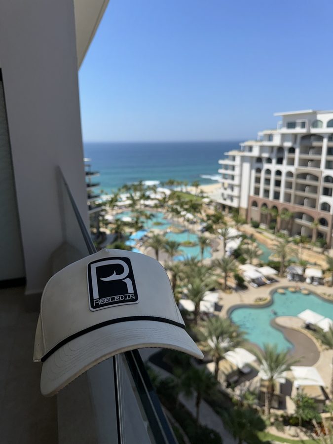 Reeled In hat on a balcony above the Gulf