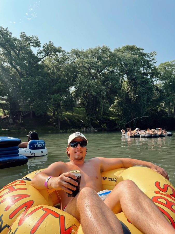 Customer floating the river in a Reeled In hat