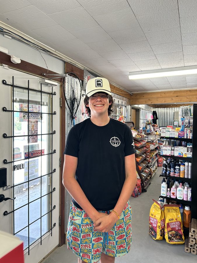 Customer wearing a Reeled In hat at the shop