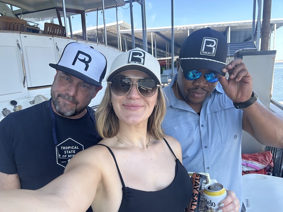 Three friends on the boat in Reeled In hats