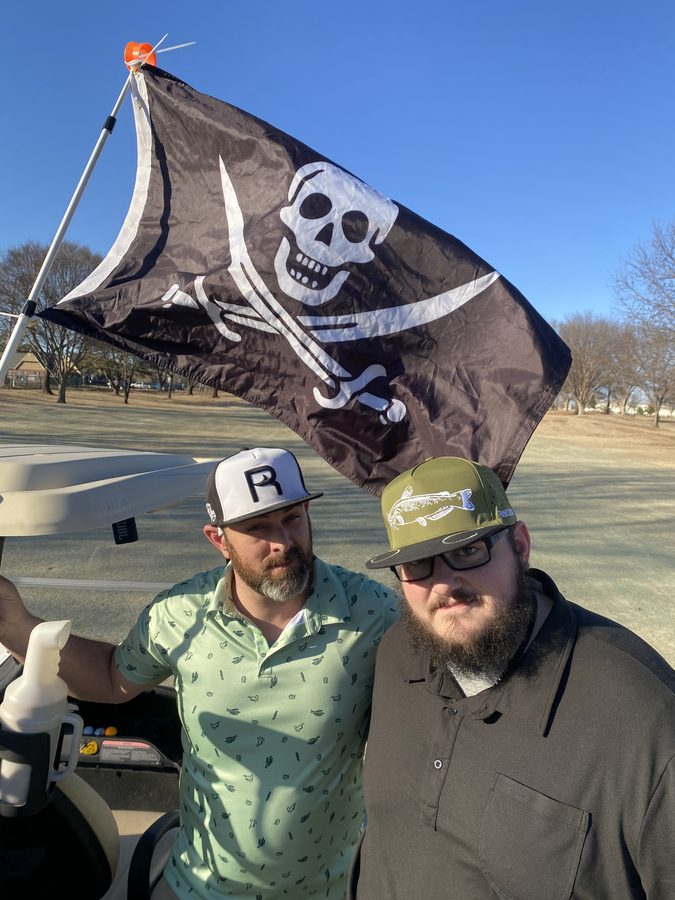 Two customers on the boat under a flag